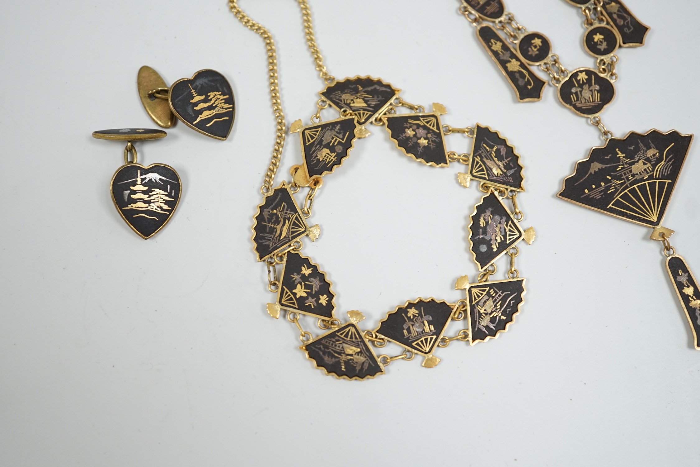 A Japanese gilt damascened iron work suite of jewellery: necklace, bracelet and a pair of cuff links